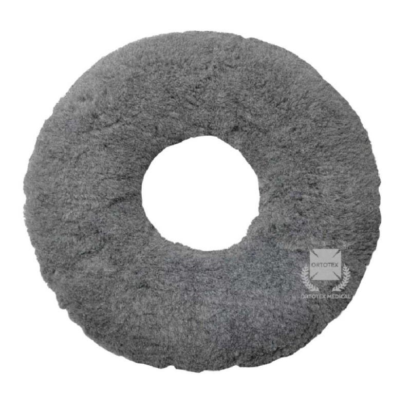 Cojín antiescaras redondo con orificio central para alivio de presión, tejido gris de borreguito y poliuretano.