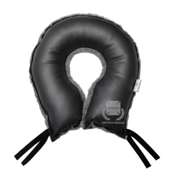 Cojín antiescaras en forma de herradura gris para alivio de presión y soporte de caderas.